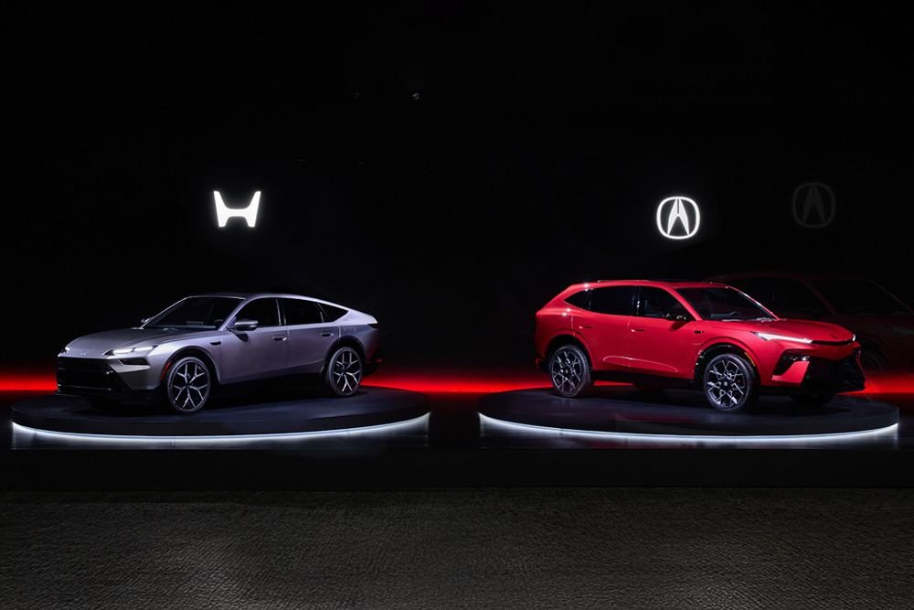 Sleek silver and bold red cars are showcased on illuminated platforms against a dark backdrop, exuding a futuristic and stylish tone.