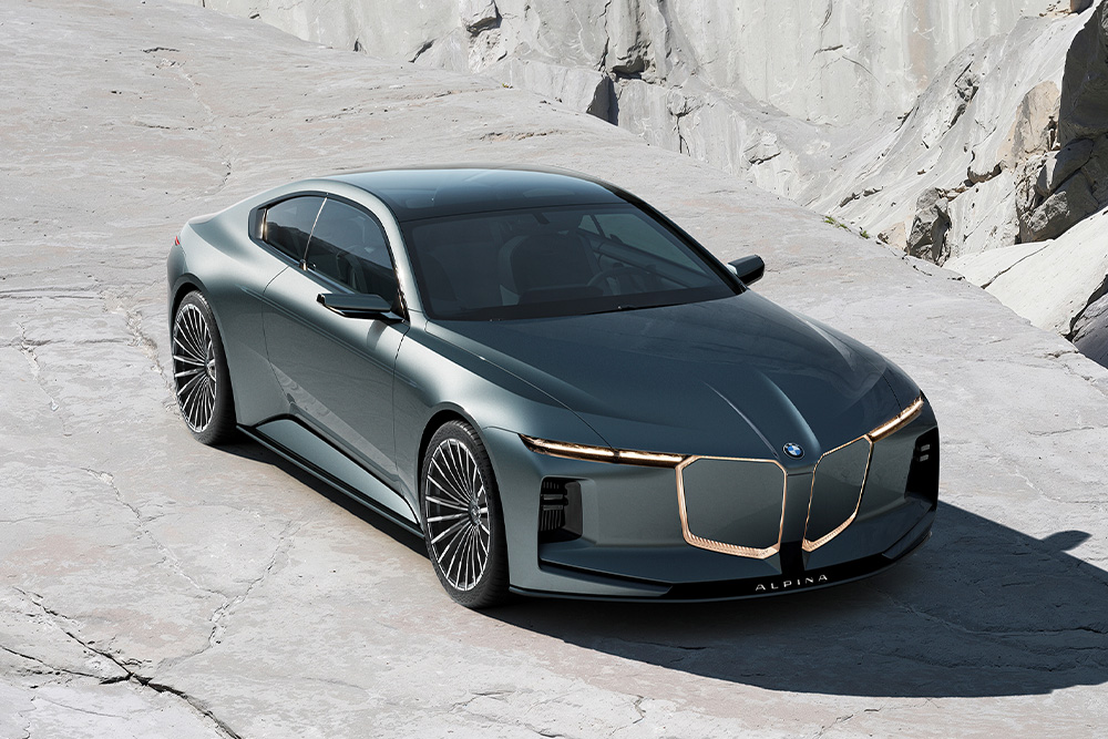 Sleek dark gray luxury sedan BMW ALPINA with a futuristic design and large grille on a stone surface. The car's modern elegance is accentuated by its sharp lines.