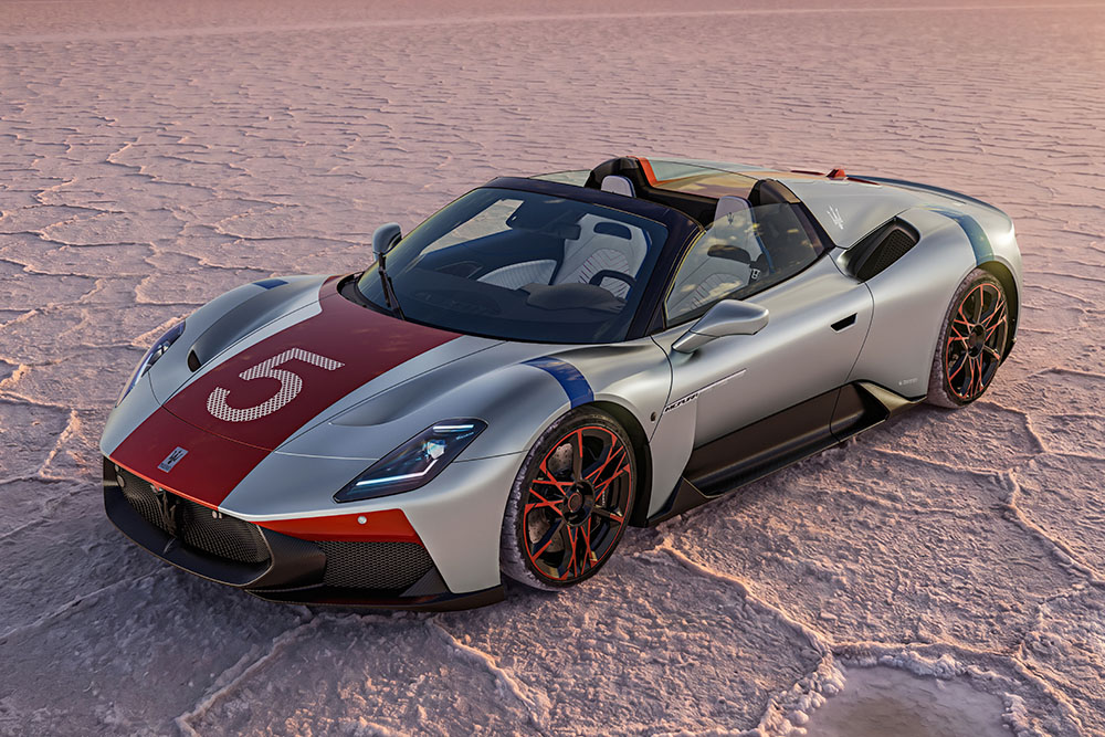Silver Maserati MC20 Cielo convertible supercar with racing number 5 parked on a dry salt flat desert.